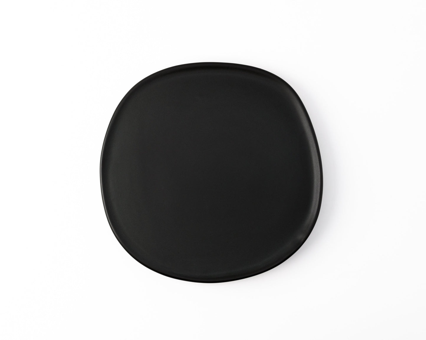 Black matte square ceramic plate with rounded edges on white background
