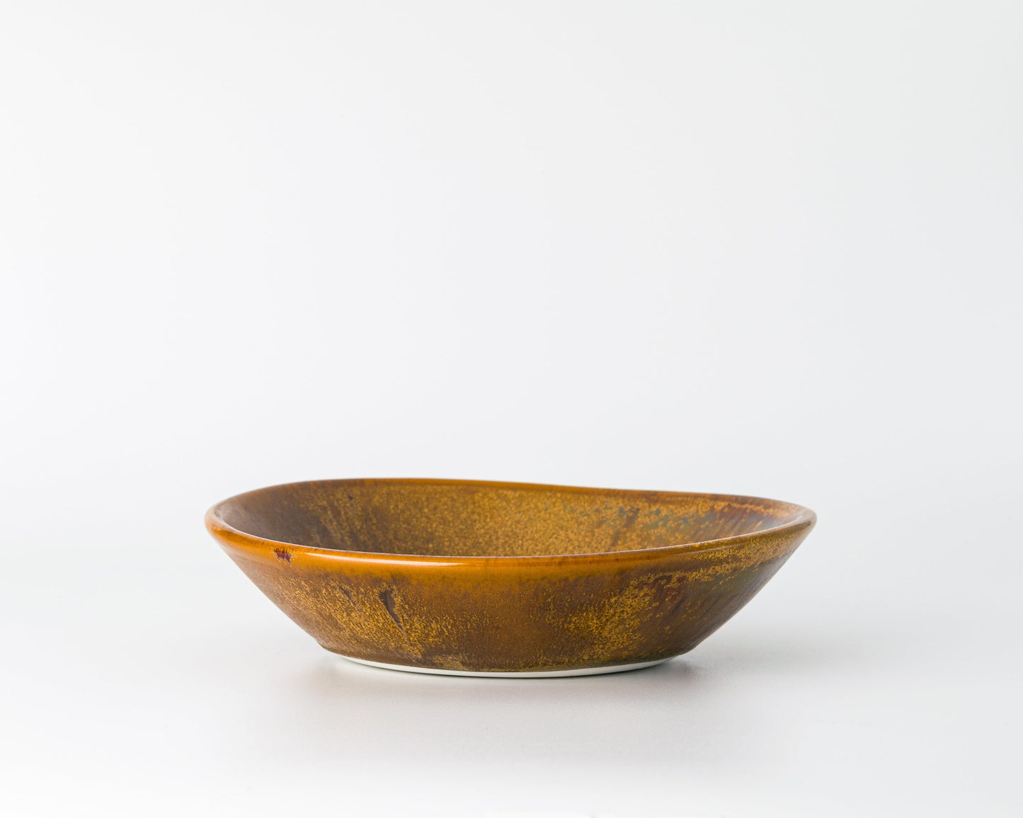Brown rustic ceramic soup bowl on white background