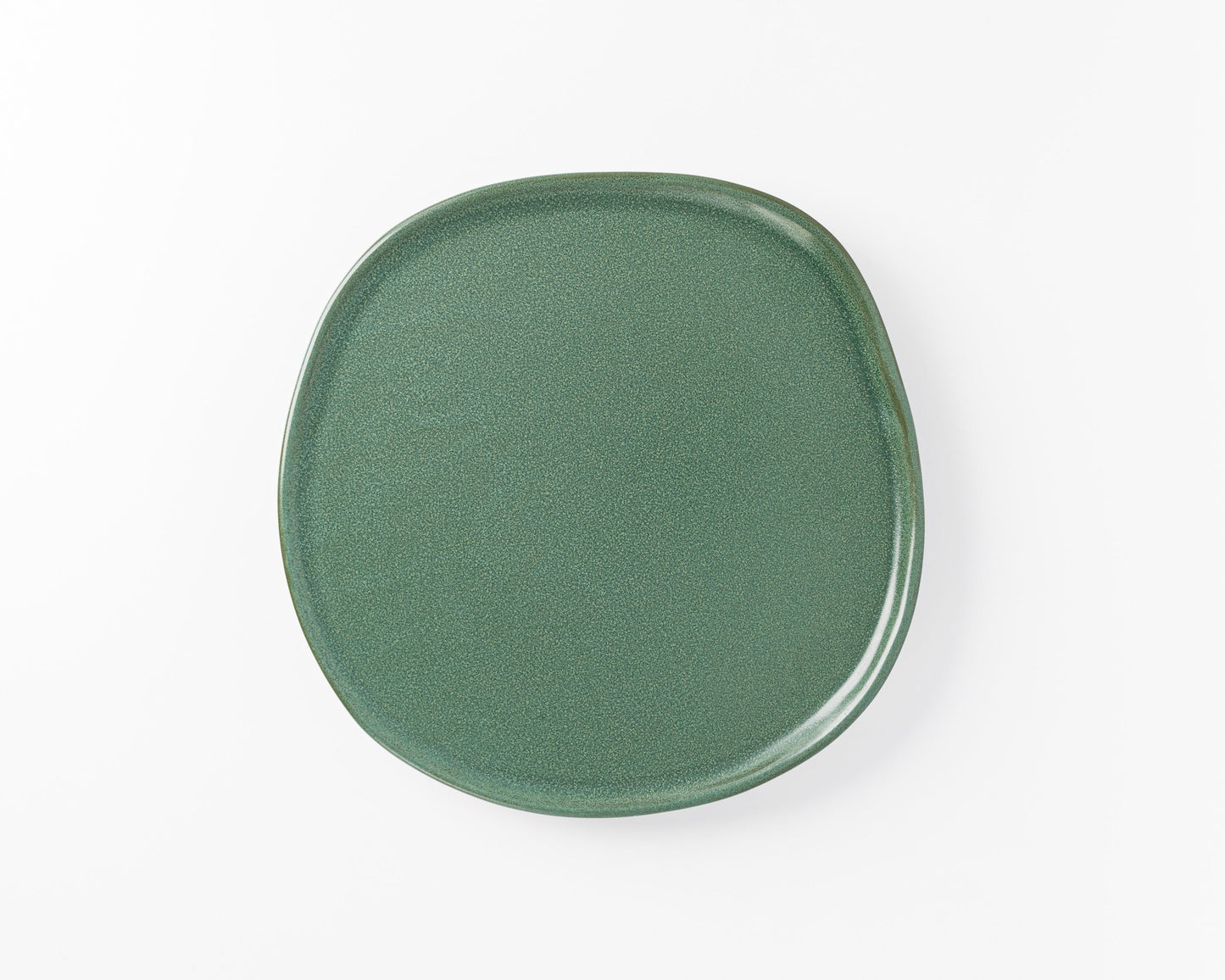 Green ceramic irregular round dinner plate on white background