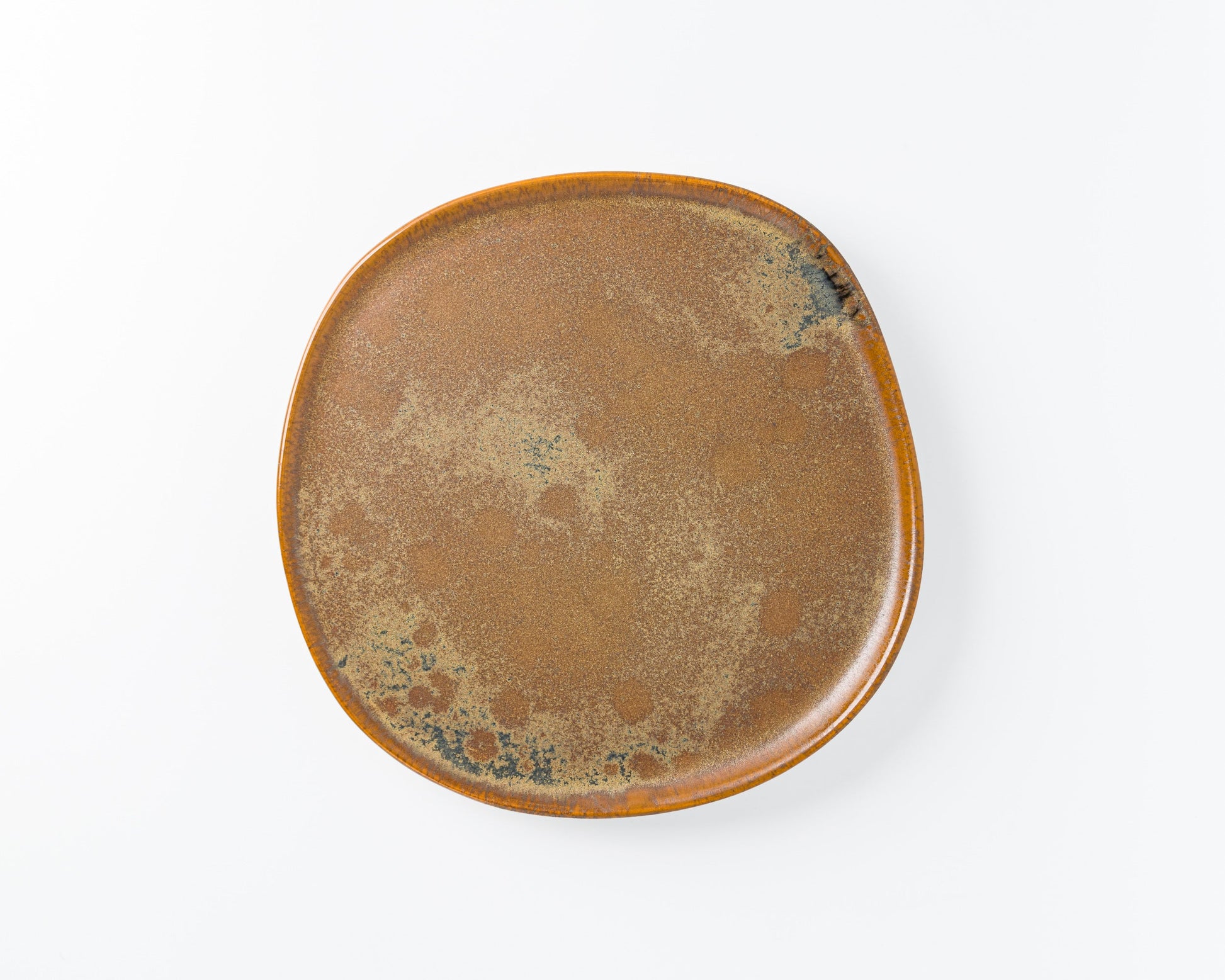 Rustic square ceramic plate with brown and speckled glazed finish on white background
