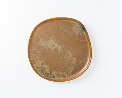 Rustic square ceramic plate with brown and speckled glazed finish on white background
