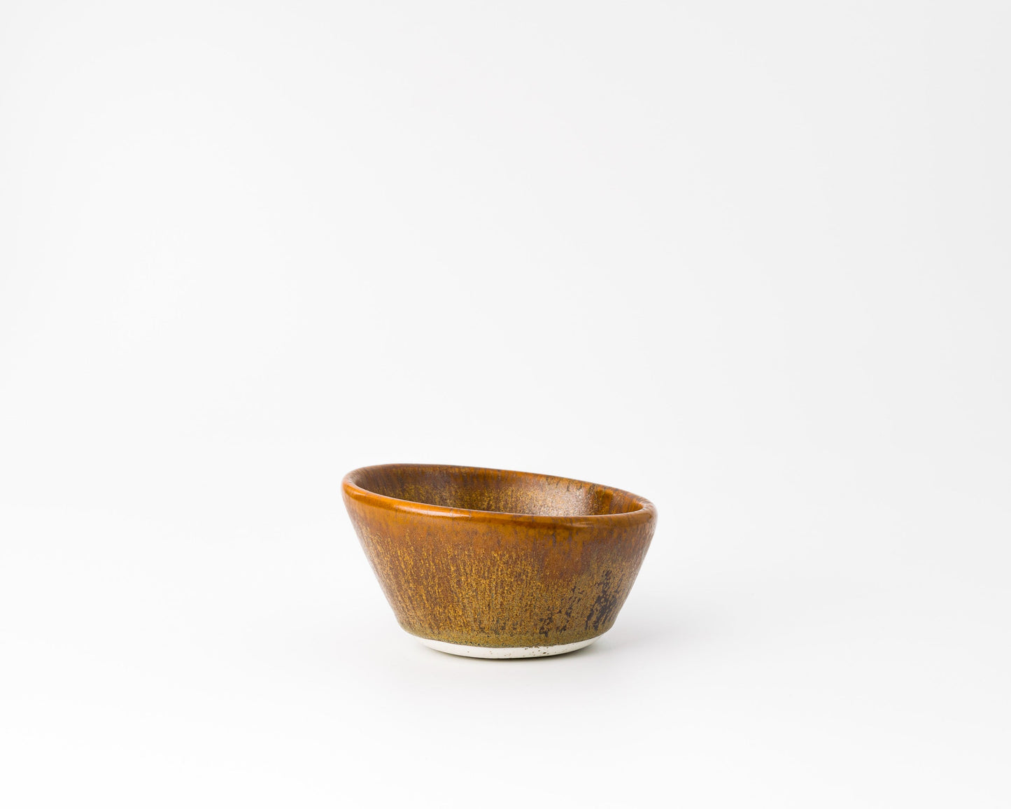 Handcrafted small brown ceramic bowl with a textured glaze on white background