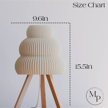 Modernized Pottery table lamp with ribbed white ceramic shade and wooden tripod legs, size 9.6 x 15.5 inches
