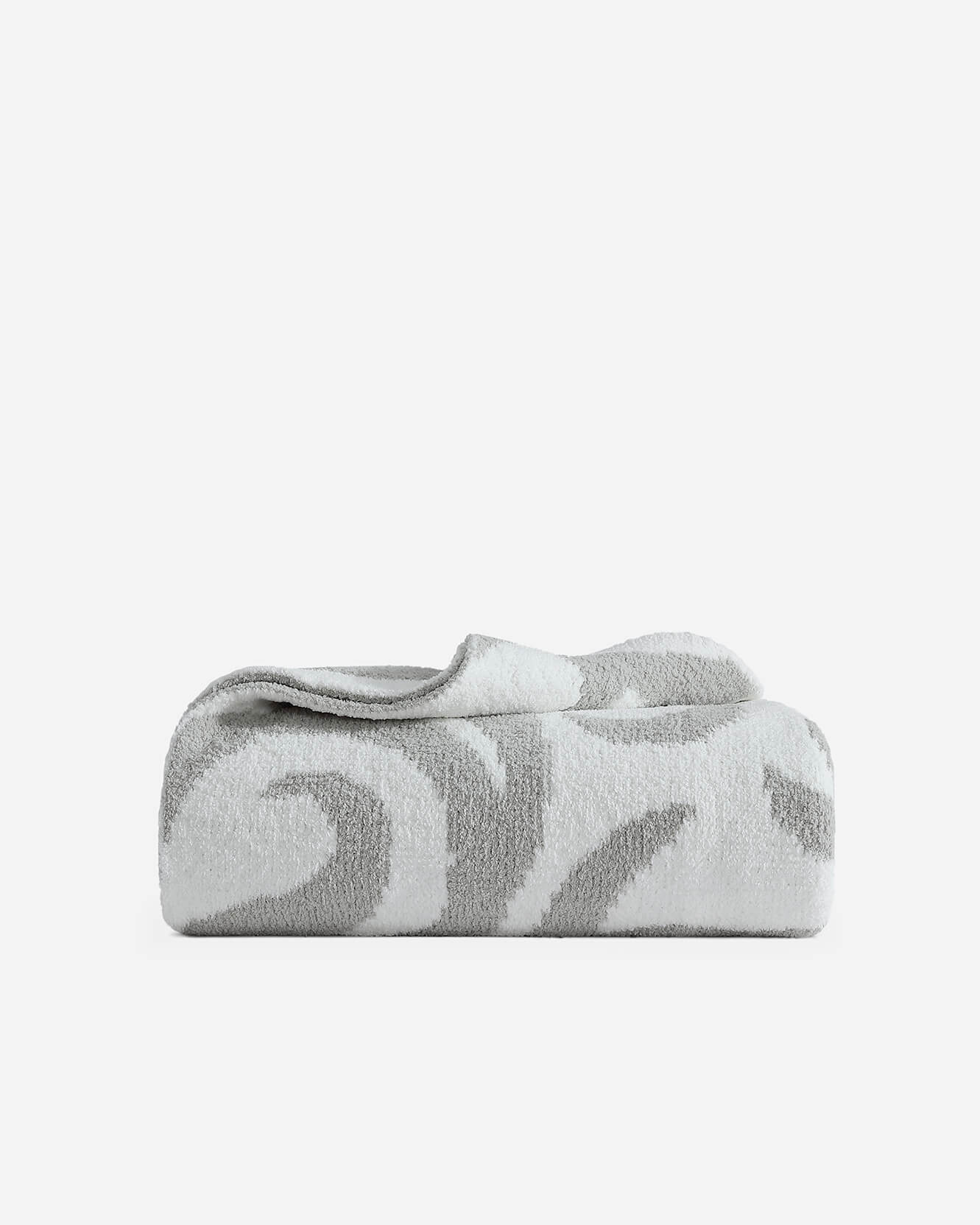 Cloud gray and off-white Casablanca patterned bed blanket folded neatly showing geometric swirl design on white background