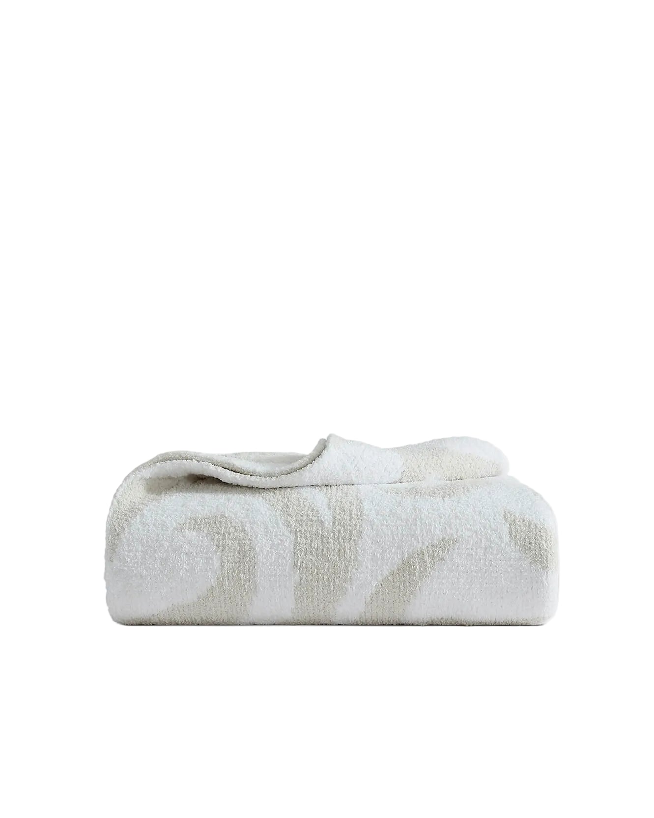 Oatmeal off-white Casablanca patterned bed blanket folded neatly showing soft geometric swirl design on white background