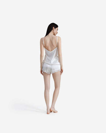 Rear view of woman showing deep V-neck detail on off-white camisole.
