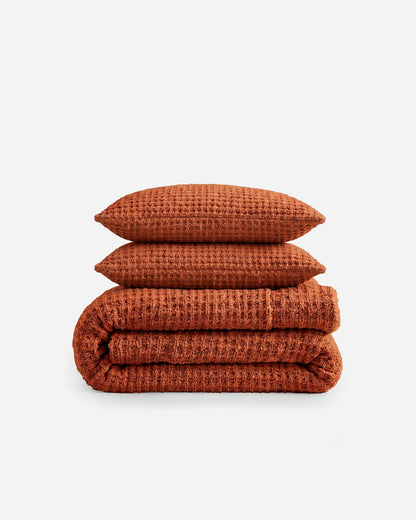 Snug Waffle Comforter Bundle in Cinnamon Stick with two shams and folded comforter stacked on white background