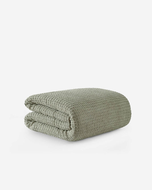 Boulder sage green Snug Waffle comforter folded neatly showing plush waffle texture and recycled fill construction on white background