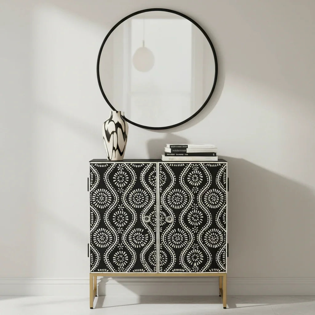 Modern black and white patterned cabinet with gold legs, round mirror, and decor in stylish home