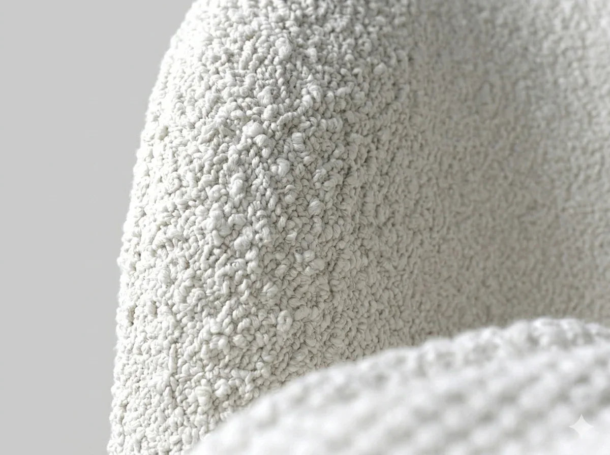 Macro close-up capturing the ultra-sharp, tactile texture of the looped white boucle fabric on the cream white boucle barrel chair.