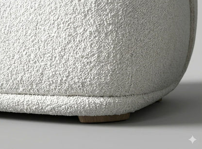 Close-up view of the solid wood base and precision stitching on a white boucle barrel chair showcasing high-quality construction and textured upholstery detail.
