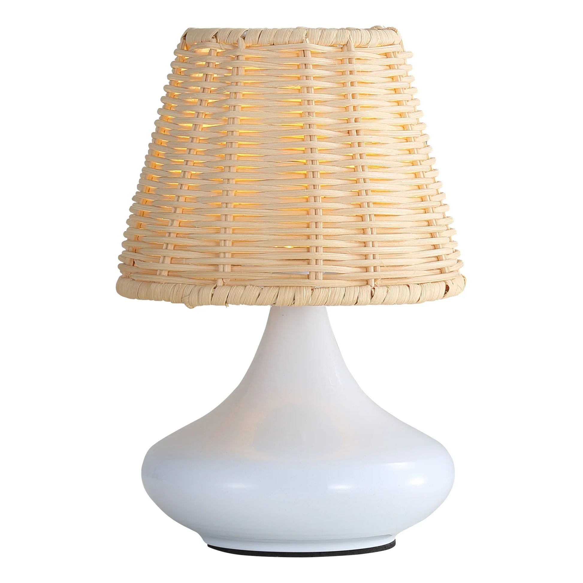 White ceramic table lamp with woven rattan lampshade emitting warm light