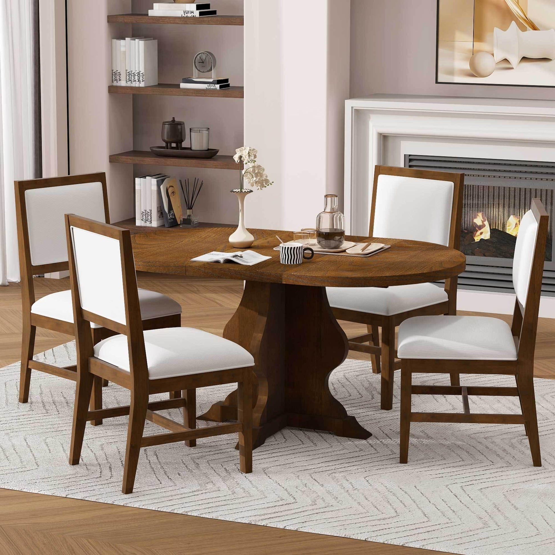Round wooden dining table with white cushioned chairs set on light rug near fireplace and shelves