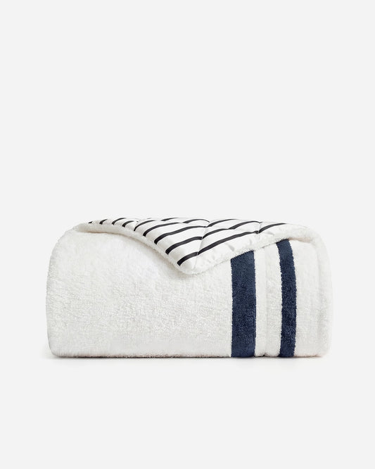 Amarena Snug Striped Comforter folded in midnight navy and off white striped cotton