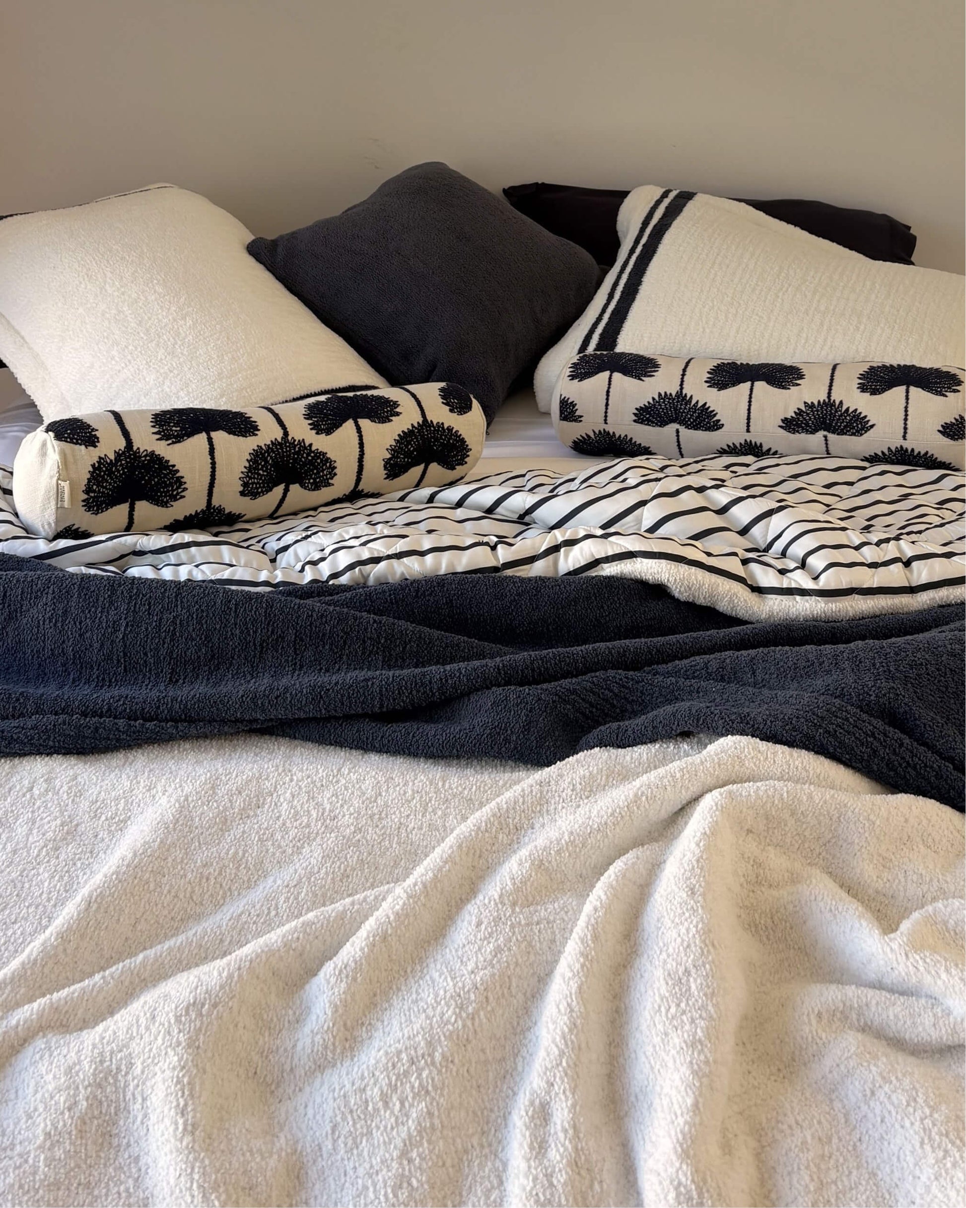 Amarena Snug Striped Sham Set styled on bed in layered bedding midnight navy and white 