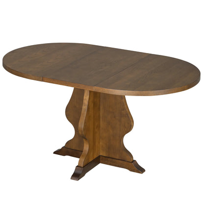 Oval wooden dining table with carved pedestal base in warm brown finish