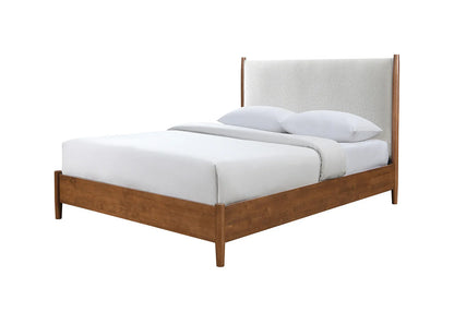 ​Platform bed frame crafted in rich walnut wood with an integrated tall beige boucle headboard, shown with a pristine white mattress and pillows