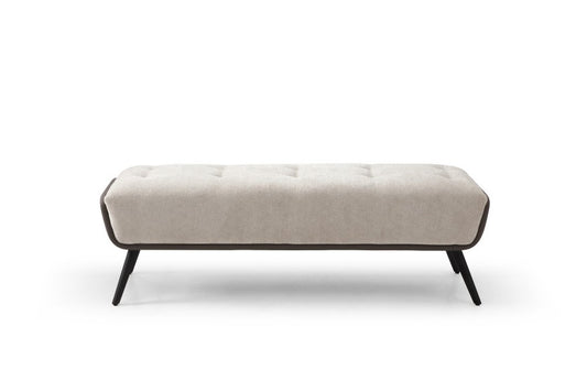 Beige button tufted vegan leather bench with dark brown vegan leather side panels and black splayed steel legs on white background