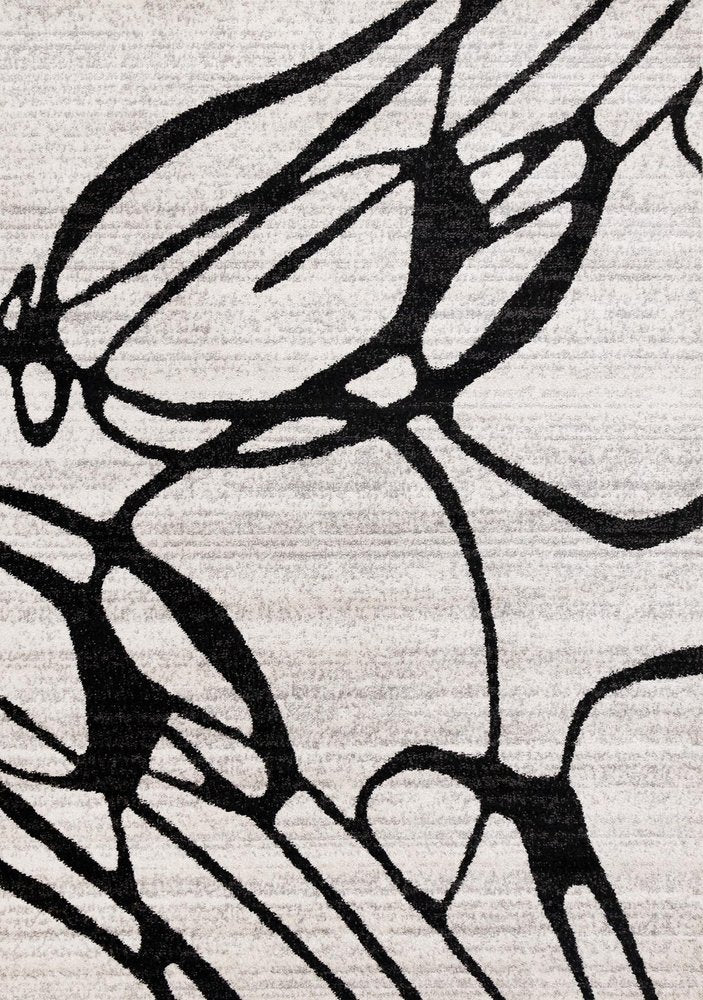 Black and gray abstract area rug close-up showing bold organic line pattern on a light ivory flat pile surface