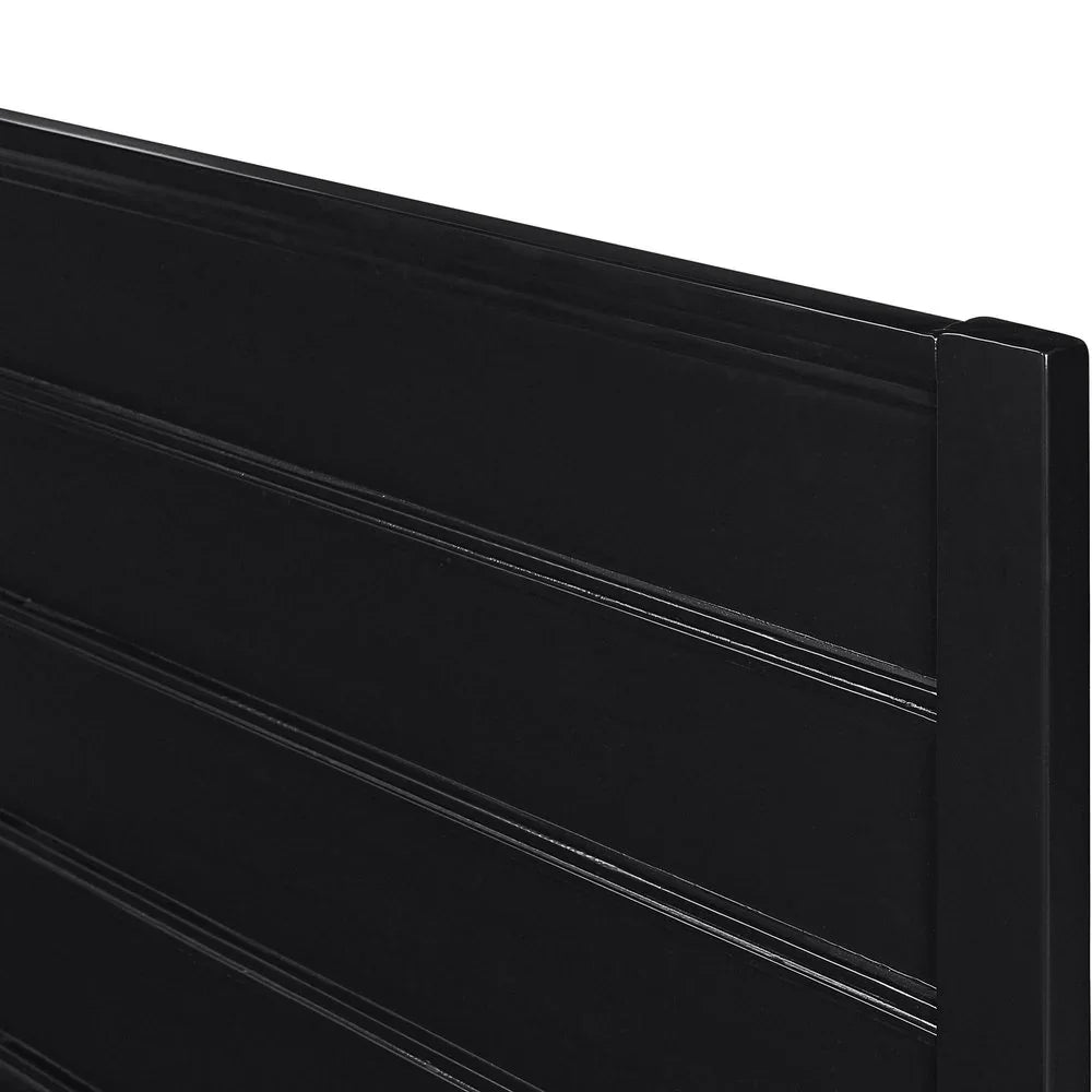 Macro view of the black solid wood headboard highlighting the modern horizontal paneling and high-quality matte finish.