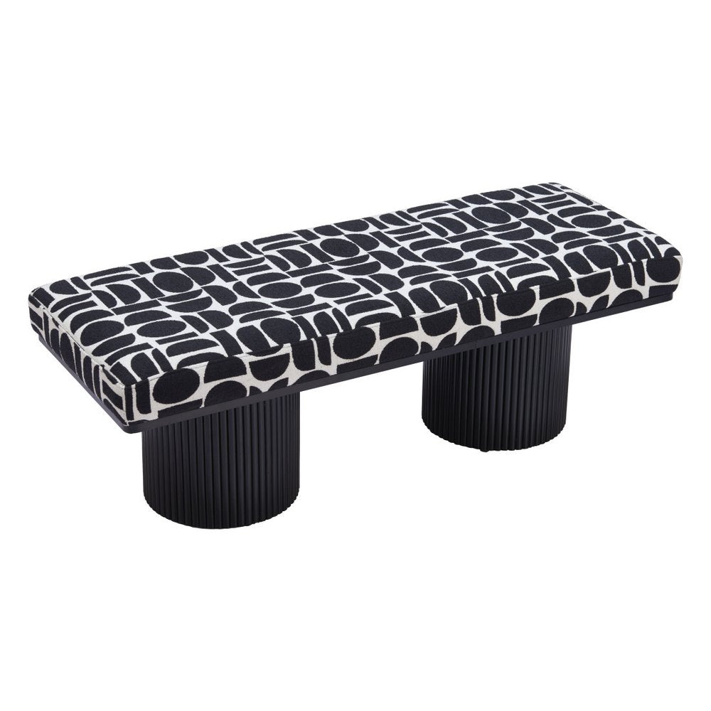 Overhead angled view of black and white geometric upholstered bench seat with dual ribbed black cylindrical pedestal legs on white background