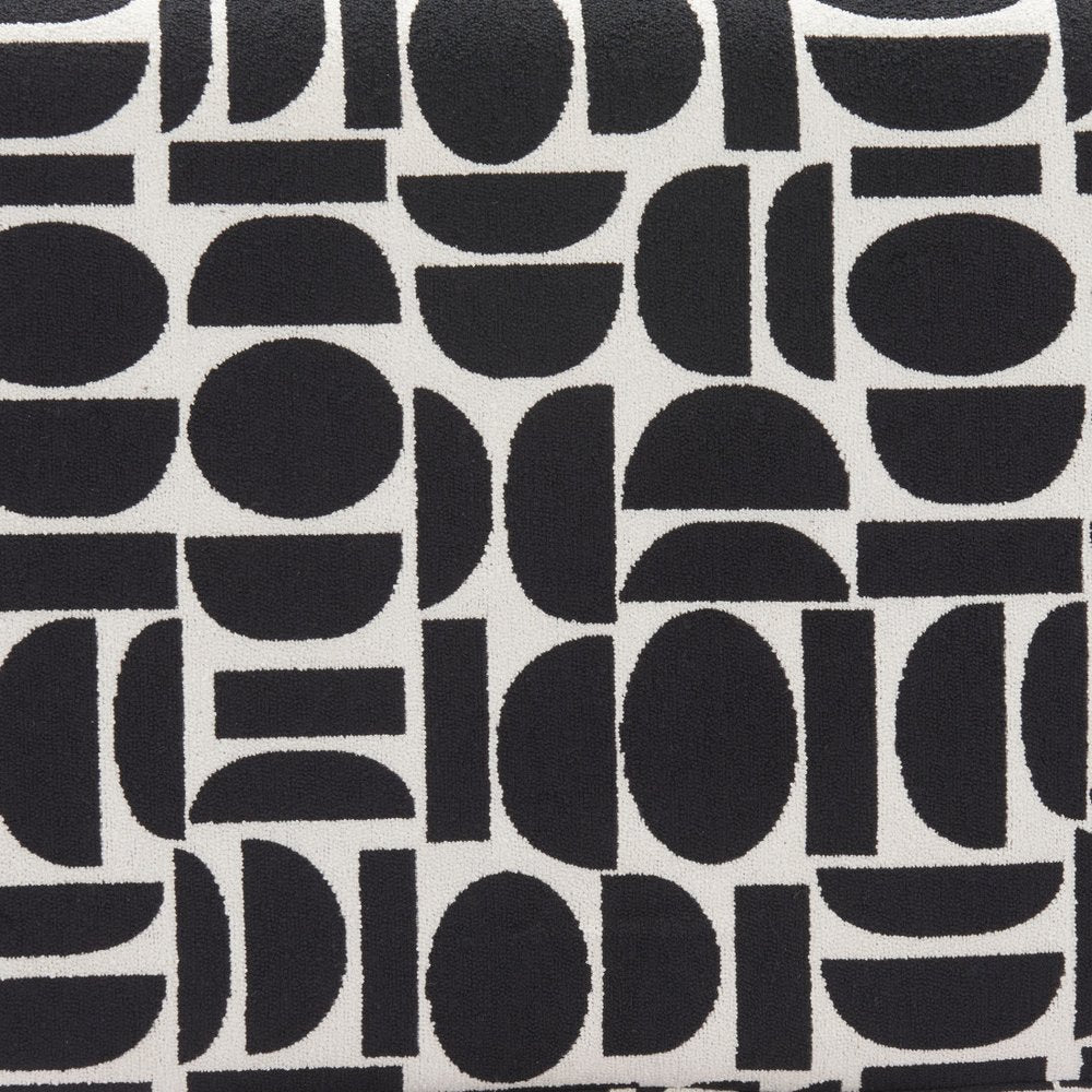 Close-up of black and white geometric polyester fabric pattern with abstract circles half-circles and rectangular shapes on bench upholstery