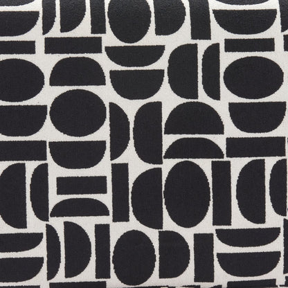 Close-up of black and white geometric polyester fabric pattern with abstract circles half-circles and rectangular shapes on bench upholstery