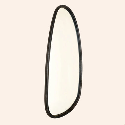 Side profile view of blackwash mango wood wall mirror showing irregular organic silhouette and slim frame depth against neutral background

