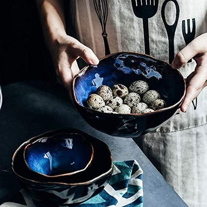Hand-painted Blue European Porcelain Dinnerware Set showcasing various sizes of dark blue glazed bowls with organic shapes for versatile artisanal dining.