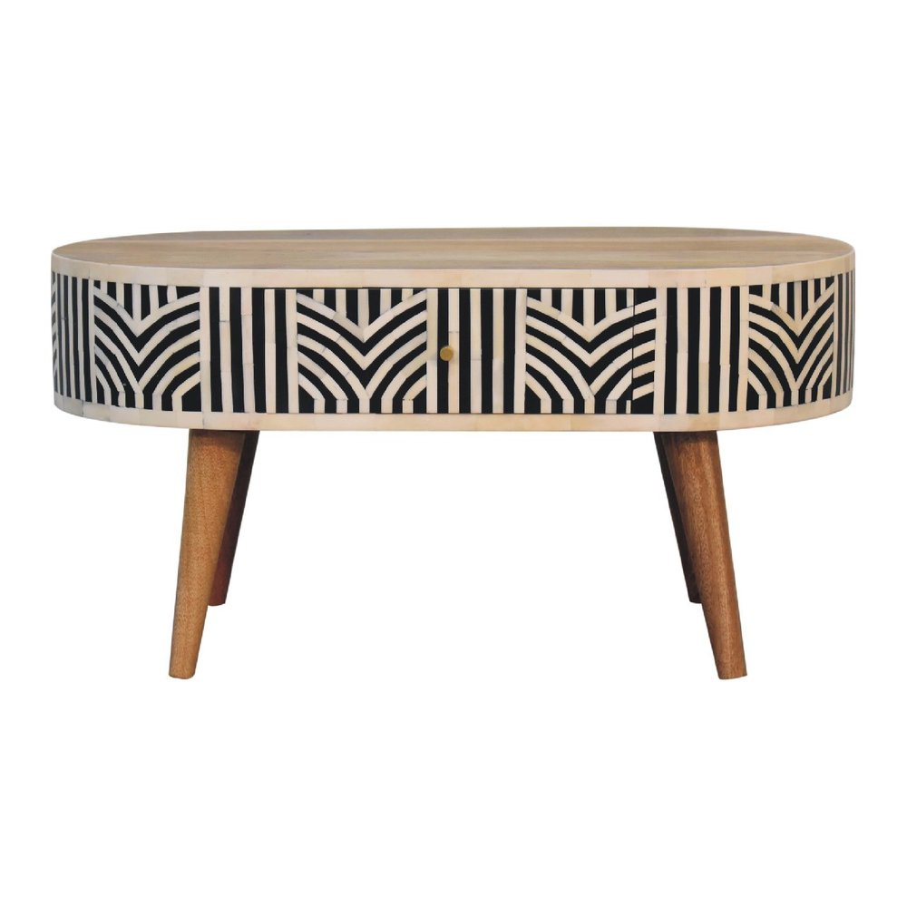Oval bone inlay coffee table with black, bone, and oak chevron pattern, center drawer, tapered wood legs on a white background