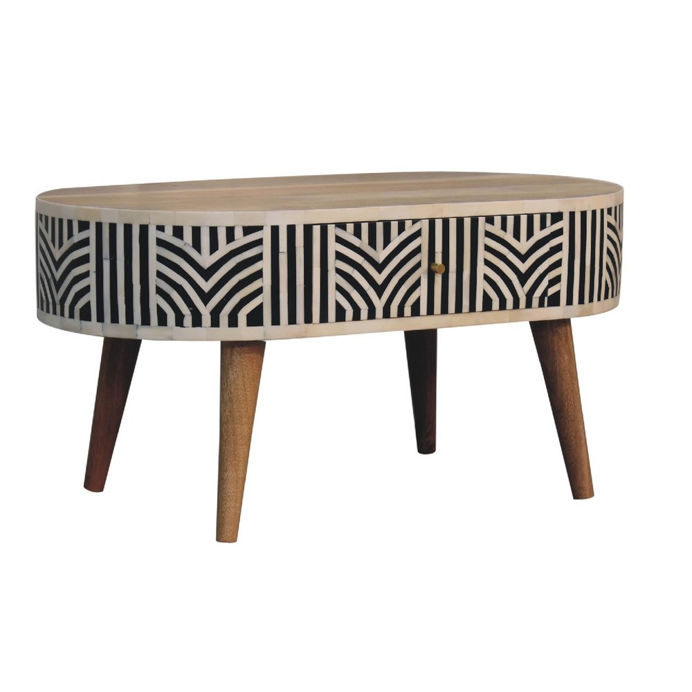 Angled view of oval bone inlay coffee table showing natural wood grain top, chevron inlay sides, and four tapered wood legs
