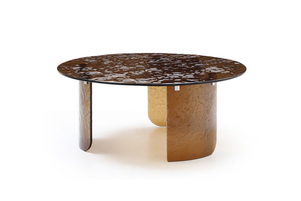 Bronze tempered glass round coffee table showing three leg sculptural bronze base with rippled texture and dark tinted round glass top on white background