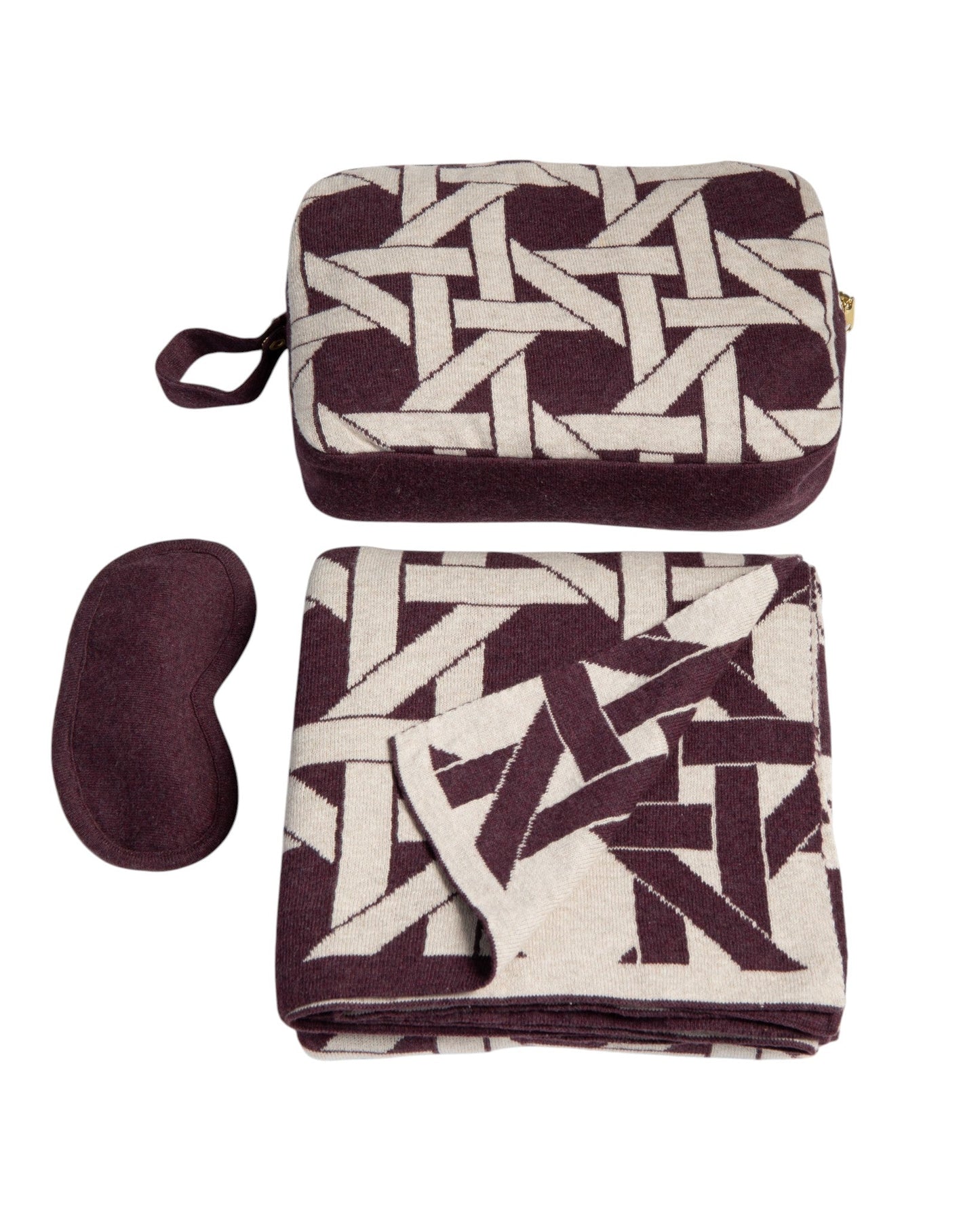 Burgundy organic cotton travel blanket set with geometric pattern including folded blanket eye mask and compact pouch