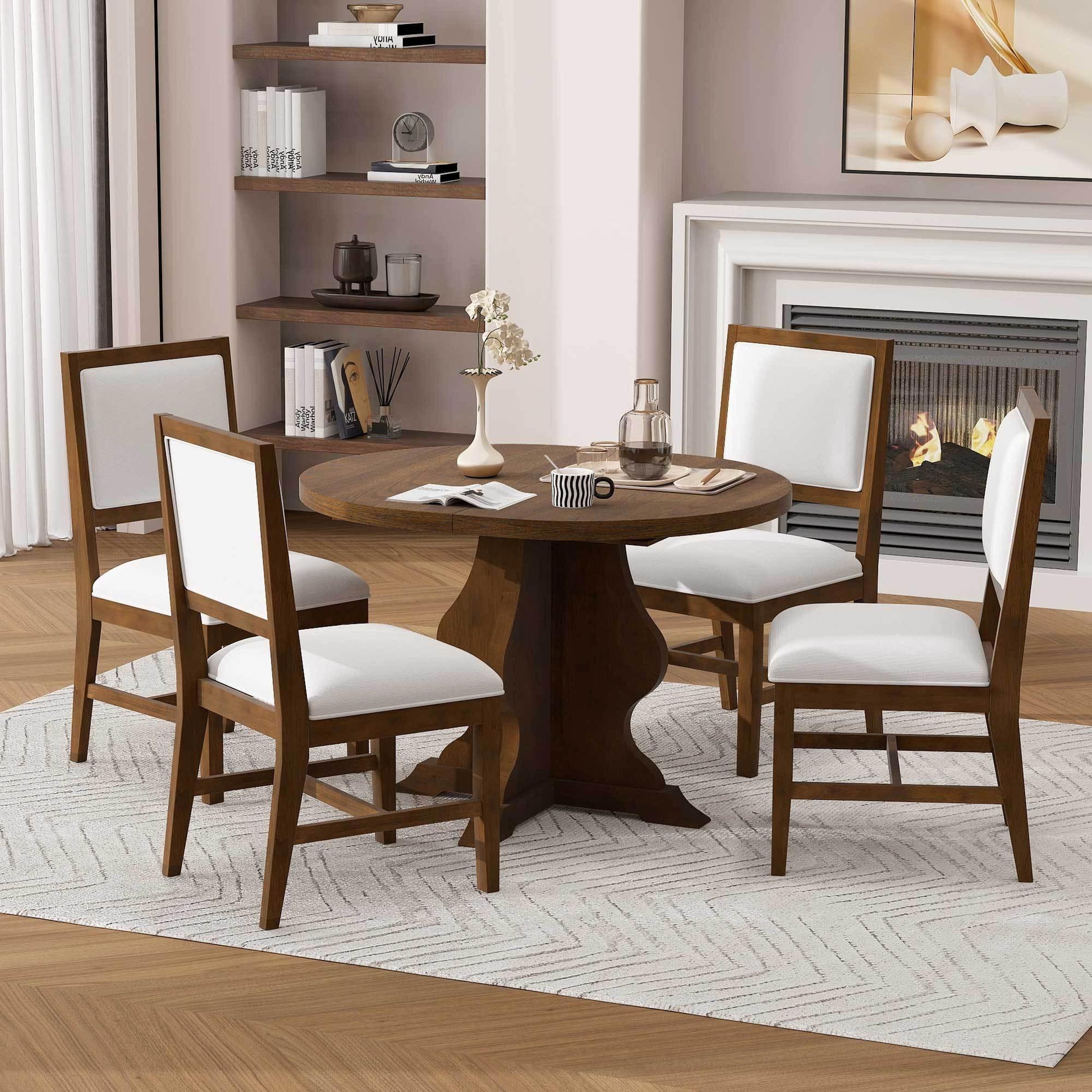 Round wooden dining table with four white upholstered chairs in modern living room with fireplace
