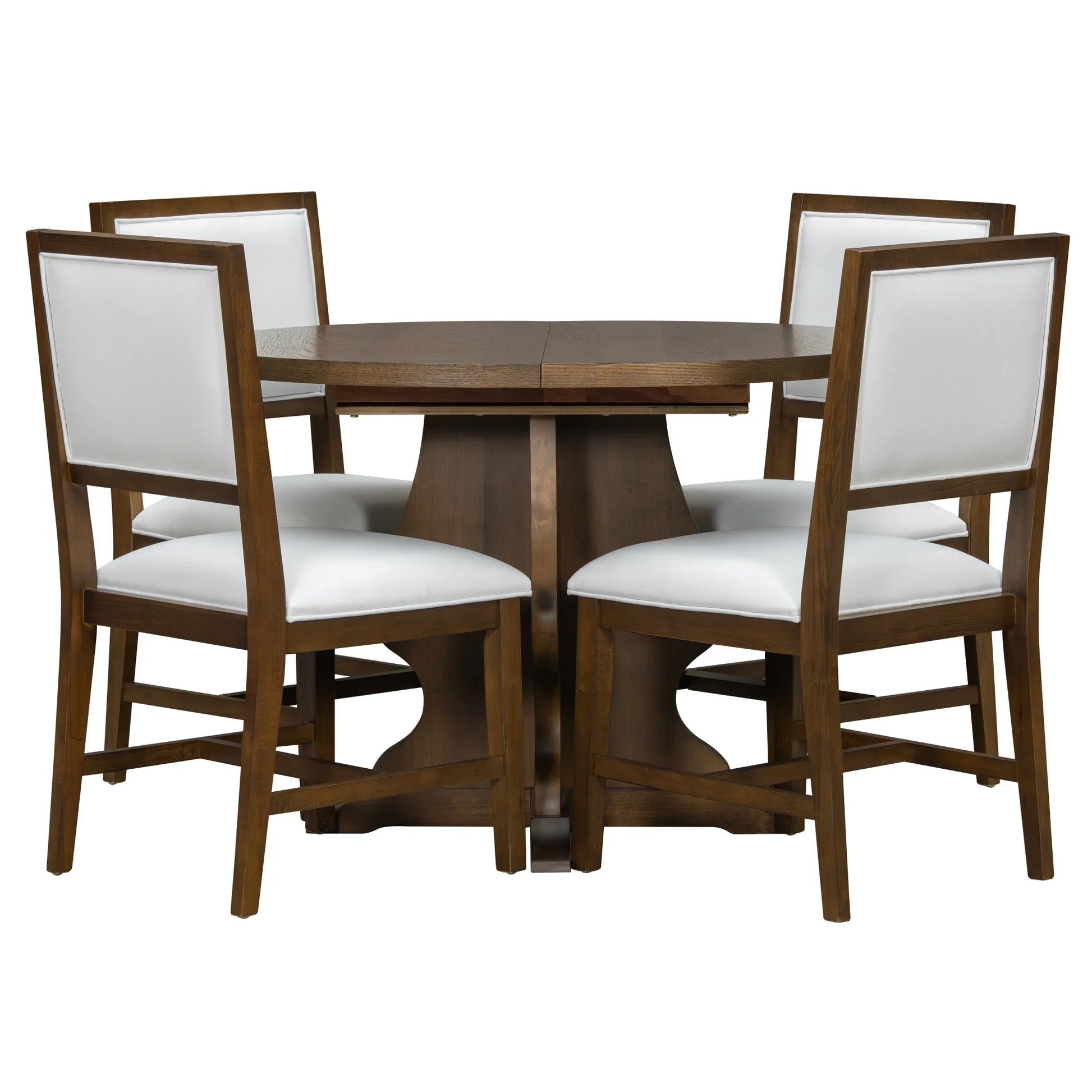 Round wooden dining table with four white cushioned chairs featuring wooden frames