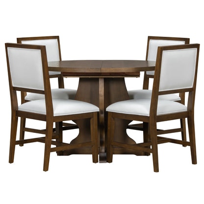 Round wooden dining table with four white cushioned chairs featuring wooden frames