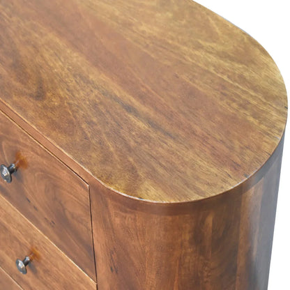 Close-up grain detail of chestnut mango wood compact cabinet showing warm amber tones natural wood figure and curved edge