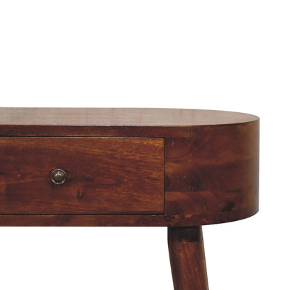 Close-up of chestnut solid wood console table showing oval top edge drawer front and metal knob pull with natural mango wood grain detail
