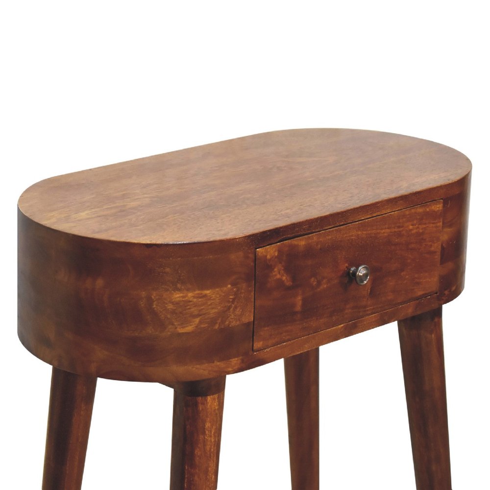 Overhead angle of chestnut oval solid wood console table showing full oval top surface drawer front with metal knob and tapered legs on white background