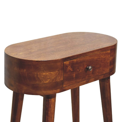Overhead angle of chestnut oval solid wood console table showing full oval top surface drawer front with metal knob and tapered legs on white background