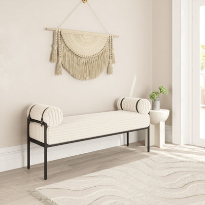 Cream corduroy upholstered bedroom bench styled in neutral living room with macrame wall hanging area rug and side table