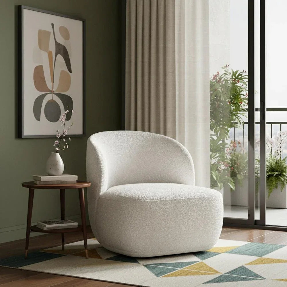 Modern lifestyle setting featuring a cream white boucle barrel chair styled on a geometric rug against a deep olive green wall.