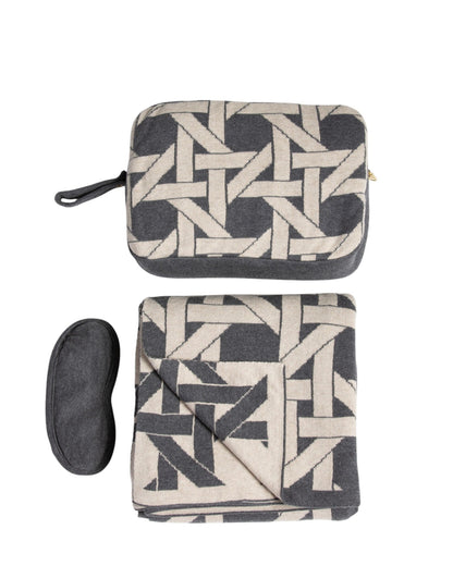 Dark gray organic cotton travel blanket set with geometric pattern including folded blanket eye mask and compact pouch