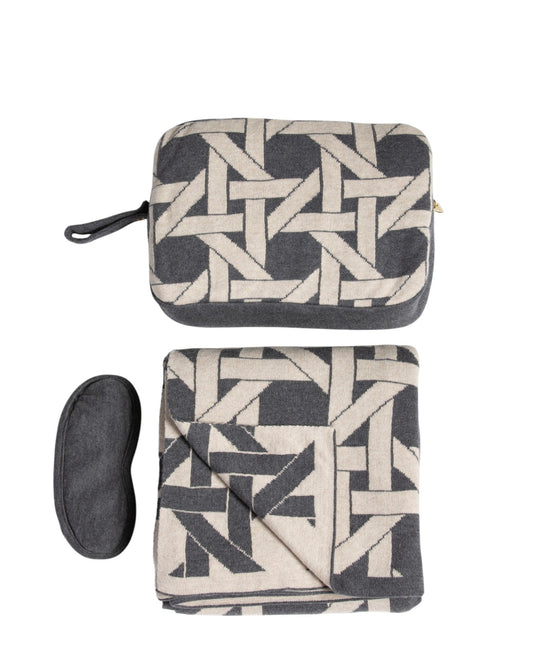 Dark gray organic cotton travel blanket set with geometric pattern including folded blanket eye mask and compact pouch
