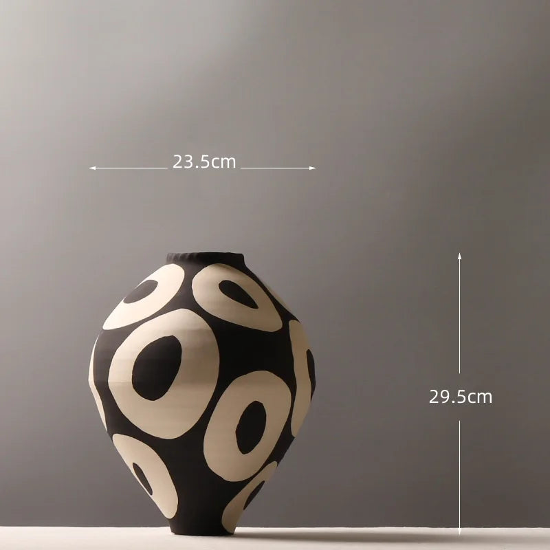 Aurelia geometric decorative vase dimension diagram showing a width of 23.5 cm and height of 29.5 cm, with light circular patterns on a dark rounded body.