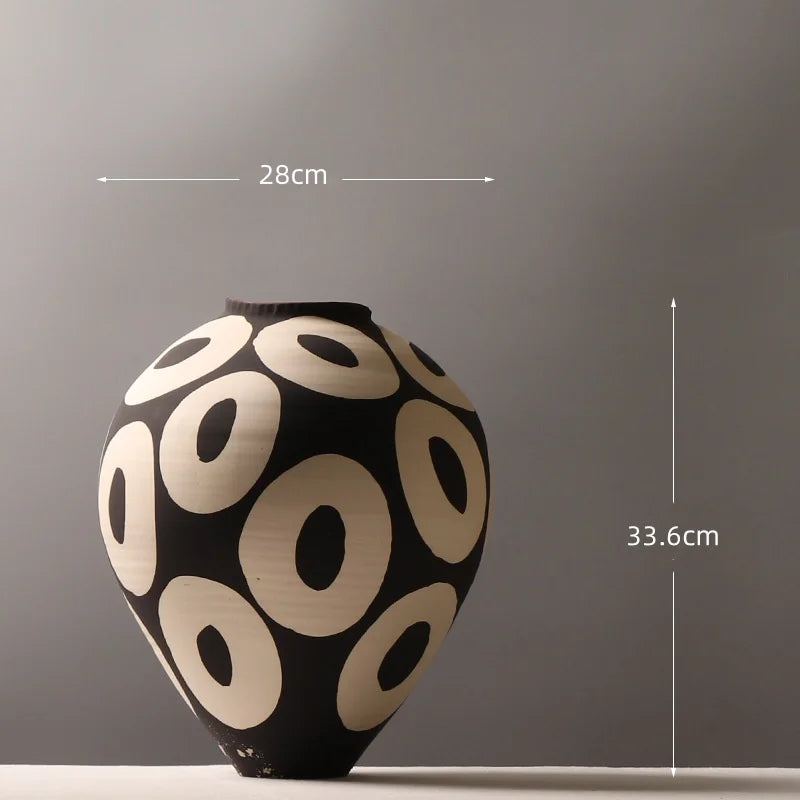 Aurelia geometric decorative vase dimension diagram showing a width of 28 cm and height of 33.6 cm, with light circular patterns on a dark rounded body.