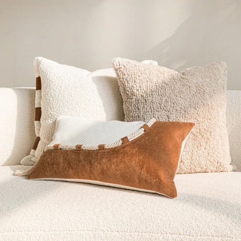 Wabi-sabi lumbar and square pillow covers in caramel and off-white cotton-linen styled on a cream sofa