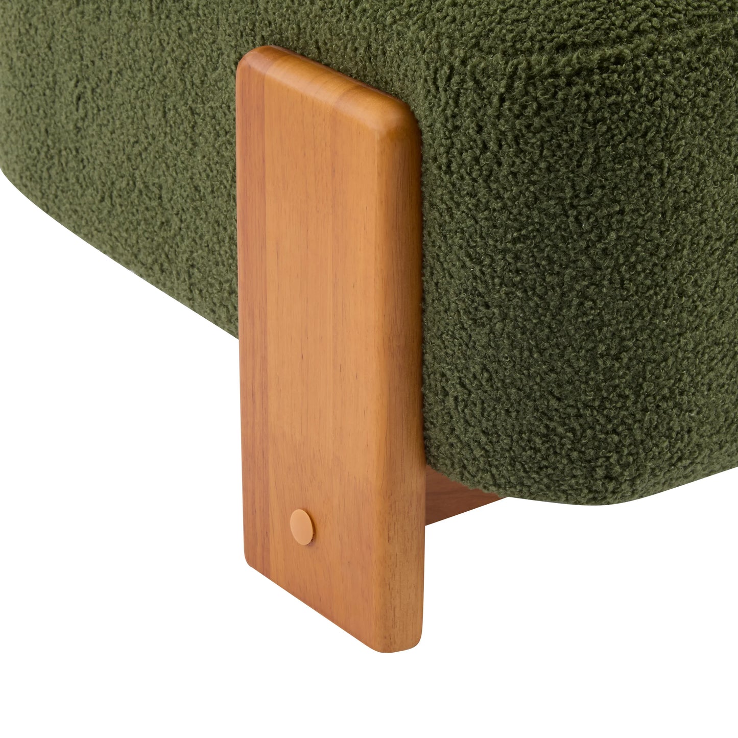 Close-up of green textured fabric sofa corner with wooden mid-century modern style leg