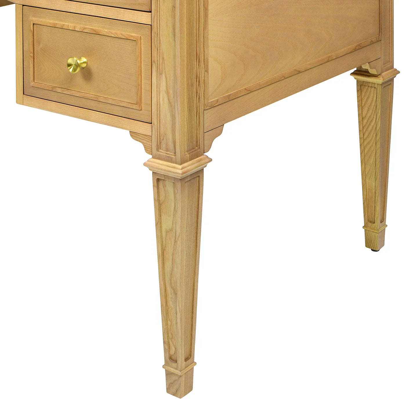 Close-up of an ash wood executive desk showing the seamless transition between the natural brown wood legs and the elegant satin-gold drawer hardware.