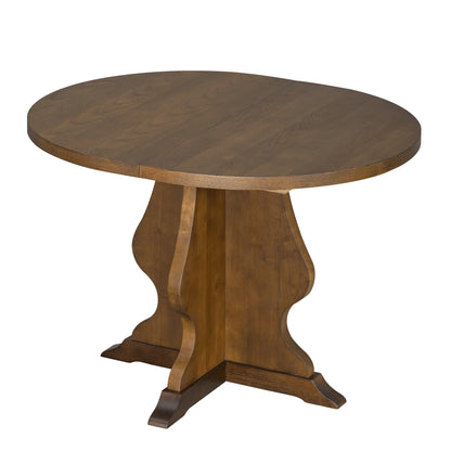Round wooden dining table with decorative pedestal base in warm brown finish